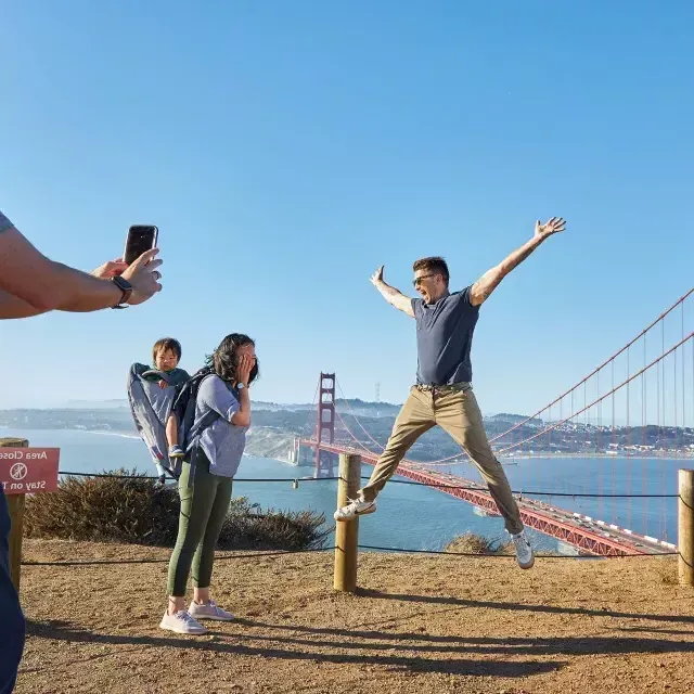 A group taking photos at the Golden Gate Bridge